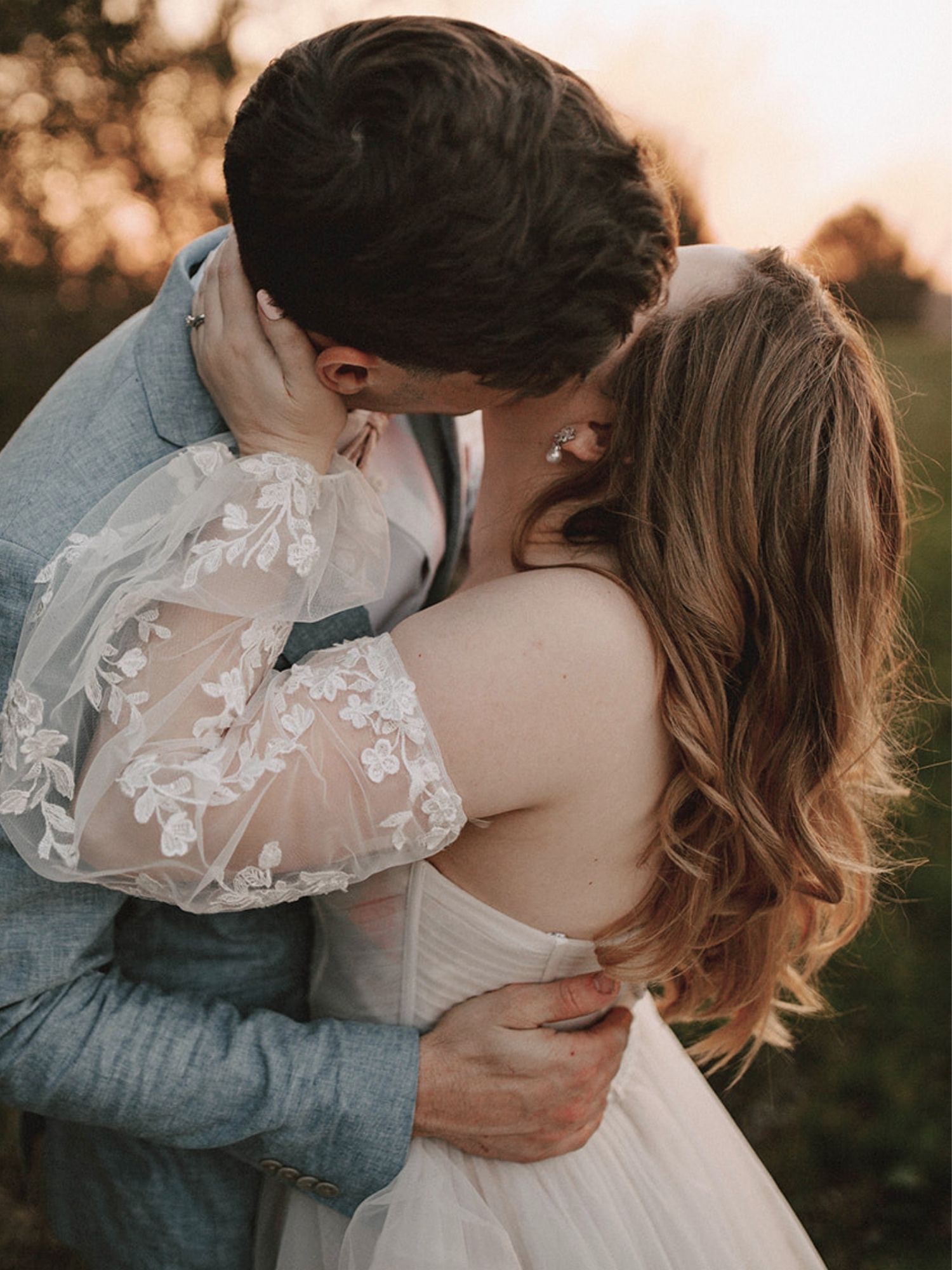 Bride and groom sharing a kiss with styled hair visible