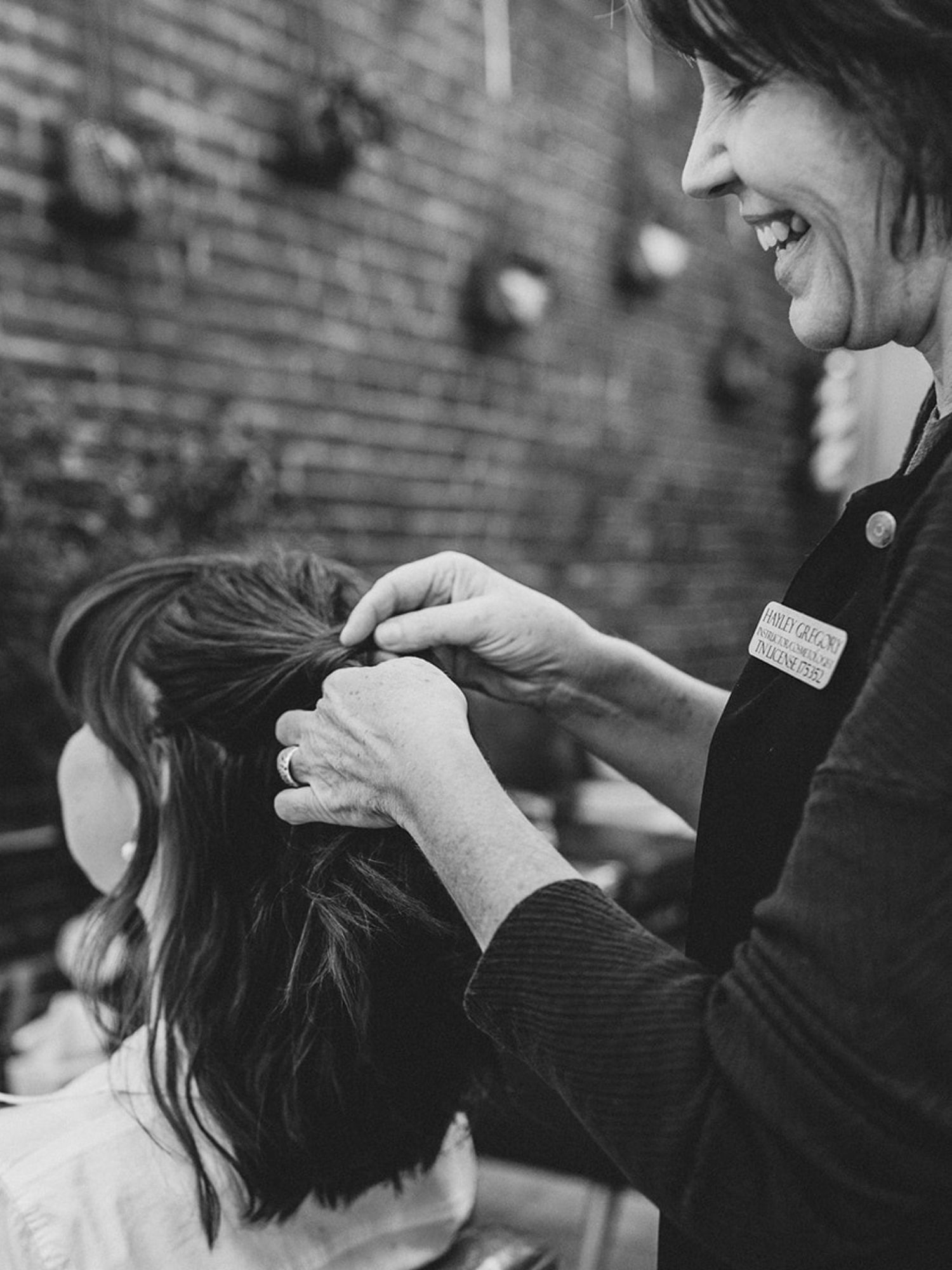 Hands styling hair during the bridal preparation process